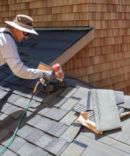 A man fixing the roof with power tools